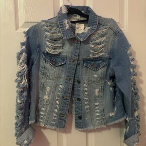 denim jacket with frayed sleeves and distressed details